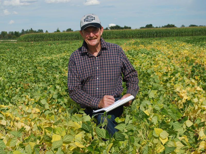 Researcher and breeder Brick in a bean field. Photo credit Barry Ogg