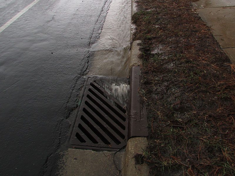 water running into storm drain