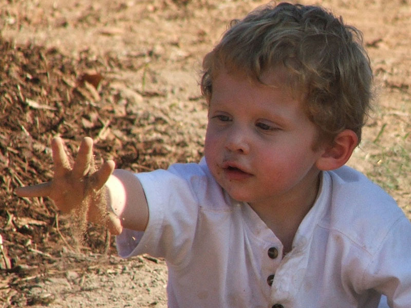 child playing in soil