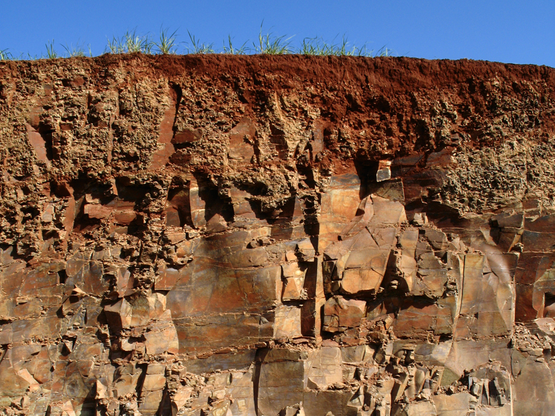 Soil profile under blue sky.