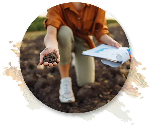 Person holding a handful of soil and a clipboard